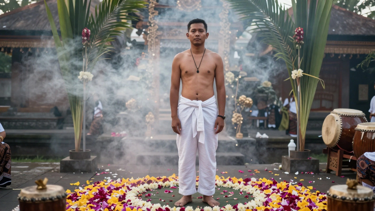Groom in white linen suit with pendant necklace, barefoot at sunrise wedding in Bali.